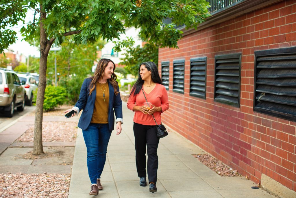 two woman going on walking meeting to increase creativity