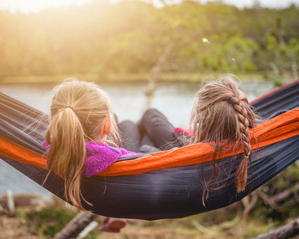 two girls sitting outside knowing that helps reduce stress.