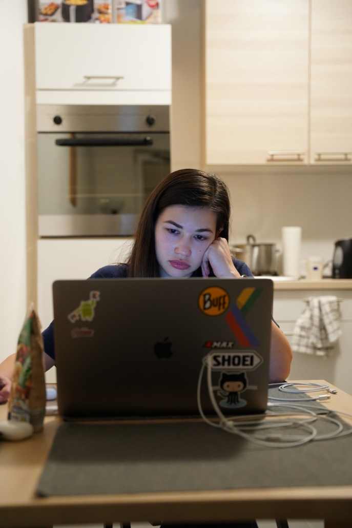 A woman facing employee burnout while sitting at her computer. 