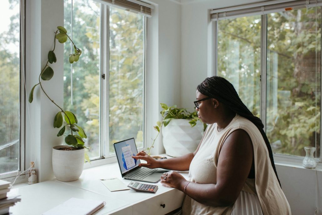 woman working from home, which allows her to maximize her productivity and focus on work.