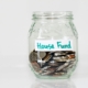 an image of a piggy bank house fund, which is one personal finance tip Navy & Sage benefits recommends setting up.