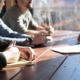 image of a group of working having a meeting outside