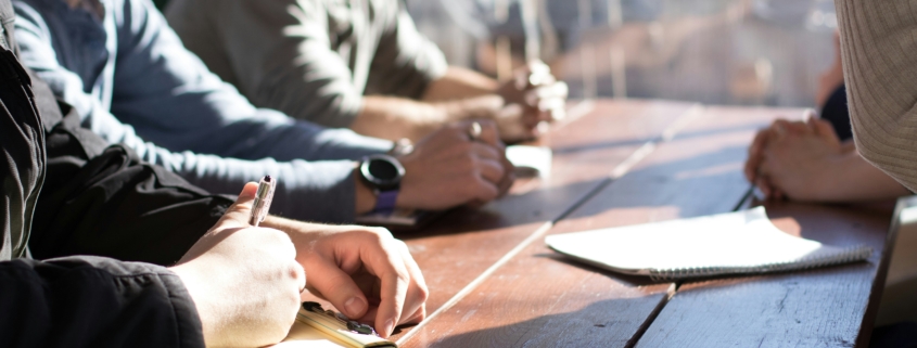 image of a group of working having a meeting outside