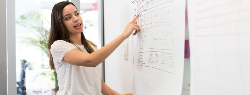 woman explaining group benefits to team members