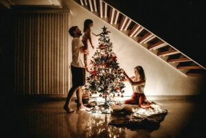 a family decorating a christmas tree